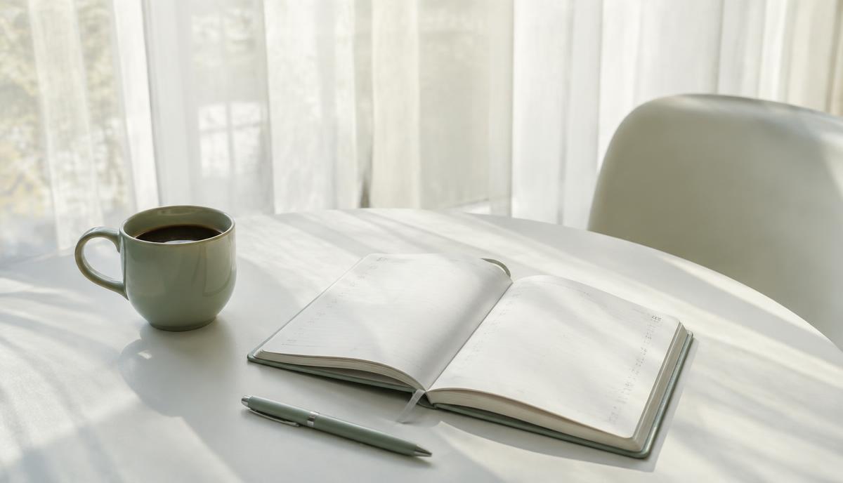 Morning light over an open planner and a cup of coffee
